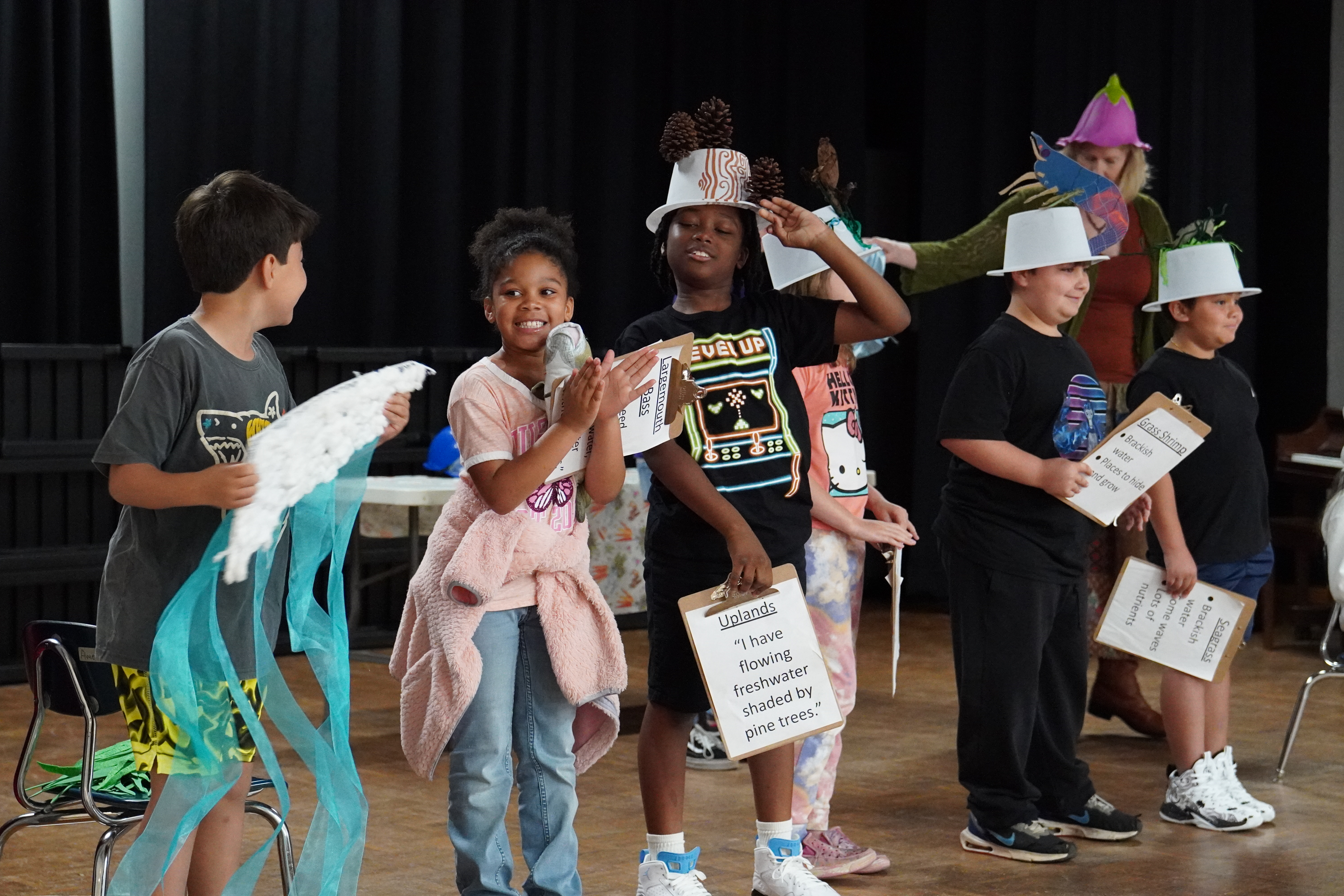 Children with props participating in the interactive A Walk in the Watershed show